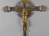 silver and gold crucifix with jesus on it on a white background