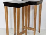 pair of mid - century modern side tables with black leather tops