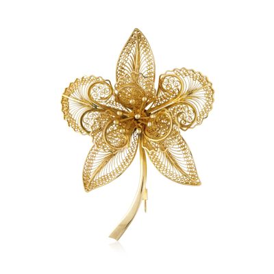 a close up of a gold brooch with a flower on it