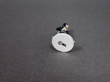 a small white object with a black and white logo on it