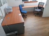 a desk with a chair and a computer on it