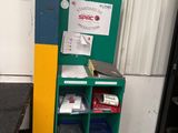a green and yellow mailbox sitting next to a black counter