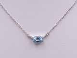 a necklace with a blue topaz stone on a silver chain