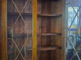a wooden china cabinet with glass doors and a mirror on top
