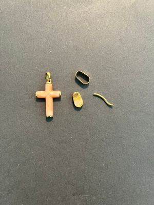 a small cross and a pair of scissors on a table