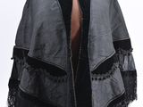 an image of a black and grey jacket with fringes on a mannequin dummy