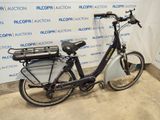 a bicycle that is parked in front of a wall