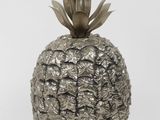 a silver pineapple shaped vase on a white background