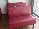 two red chairs in front of a flat screen tv