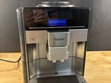 a close up of a coffee machine on a wooden table