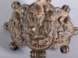 a silver turtle that is sitting on top of a table