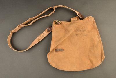 an image of a tan bag with a brown strap on it