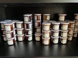 many jars of ice cream on a shelf in a store