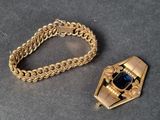 two pieces of jewelry that are on a table