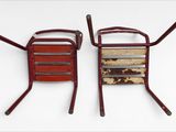 two chairs sitting next to each other on a white surface