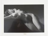 a black and white photo of a nude woman laying down