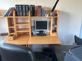 a desk with a chair and a computer on it