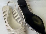two pairs of women ' s shoes are sitting on a white surface
