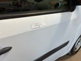 a small white car with a sticker on the side of it