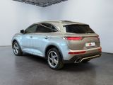the rear end of a silver suv parked in a garage