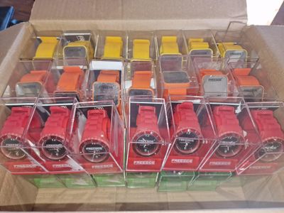 a box full of different colored watches in it