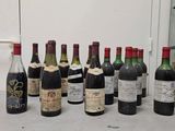several bottles of wine are lined up on a counter