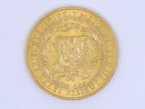 a gold coin with a coat of arms on it