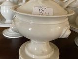 many white dishes on the table with a price tag on them