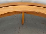 a curved wooden table with a curved top