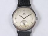 a watch that is sitting on a white surface