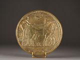 an image of a gold plate with an image of a man on a horse
