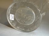 a clear glass bowl sitting on a table with a label on it