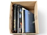 a cardboard box with a bunch of books in it