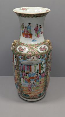 a vase with a painting on it sitting on a table