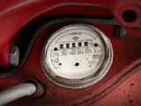 a close up of a gauge on a red car