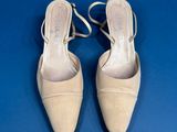 pair of beige shoes on a blue surface