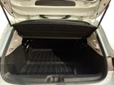 the back of a white car with its trunk open showing the cargo area