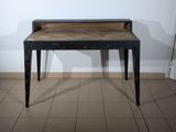 a small table with a wooden top on a tiled floor