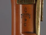 a close up view of a brass clock on a stand