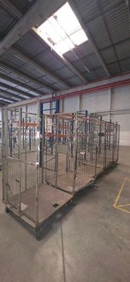a large metal cage in the middle of a warehouse