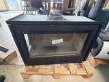 a black stove sitting on a pallet in the middle of a room