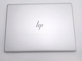 the back of a laptop computer sitting on top of a white table