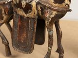 a horse that has a saddle on it ' s back