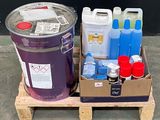 two buckets of paint and two containers of liquid sitting on a pallet
