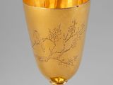 a gold goblet with a design on it