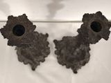 pair of antique bronze candlesticks on a white background