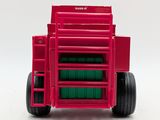 a red toy truck with a green container in the back