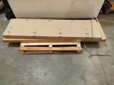 a pile of wood sitting on the floor next to a pallet