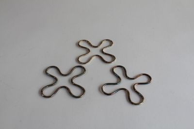 a set of four small metal rings on top of a white surface