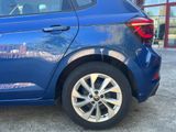 a blue car that is parked in front of a building